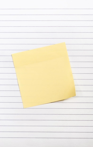 Blank yellow paper sticker on the notepad Close up