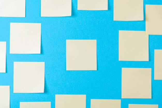 Blank yellow sticky notes on blue