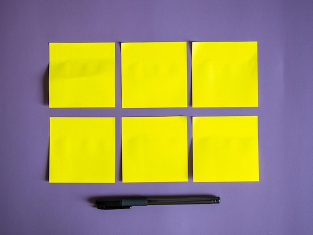 Blank yellow sticky notes on purple background