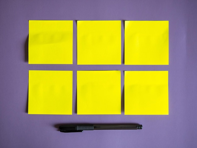 Blank yellow sticky notes on purple background