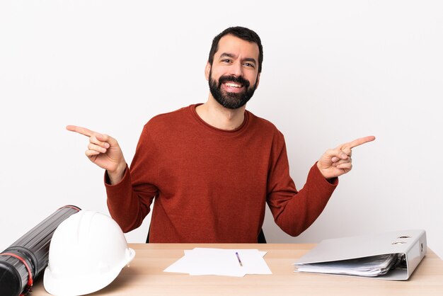 Blanke architect man met baard in een tafel wijzende vinger naar de zijtakken en gelukkig.