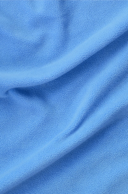 Photo the blanket of furry blue fleece fabric
