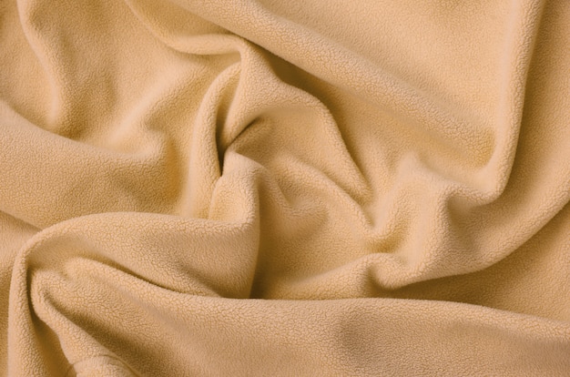 The blanket of furry orange fleece fabric. 