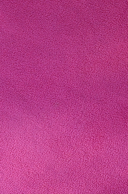 毛皮のようなピンクのフリース生地の毛布。淡いピンクの柔らかい豪華なフリース素材の背景テクスチャ