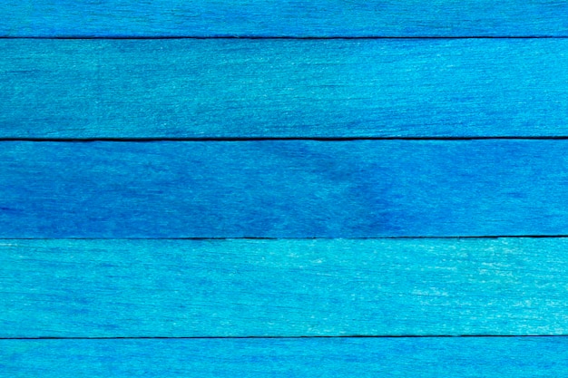 Blauw geschilderd getextureerde houten achtergrond. Blauwe houten planken horizontaal gerangschikt.