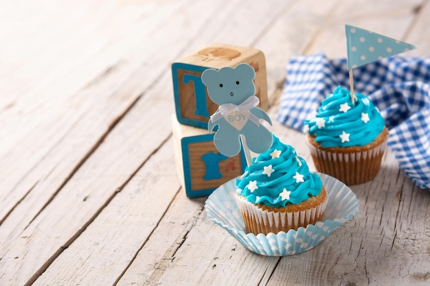 Blauwe cupcake voor babyshower op houten tafel