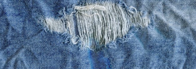 Blauwe denim jean textuur achtergrond Jeans gescheurde stof textuur