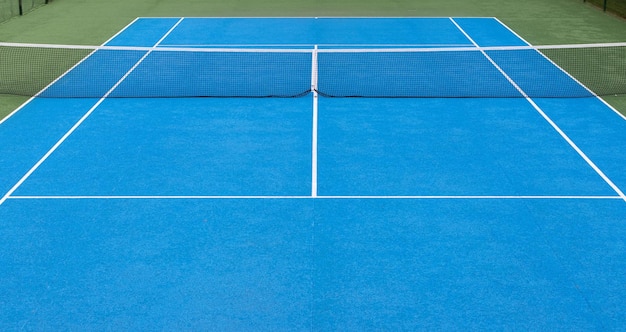 Blauwe en groene tennisbaan achtergrond