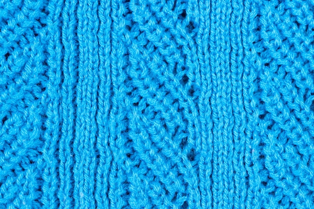 Blauwe gebreide stof met grof breiwerk. Textuur en achtergrond