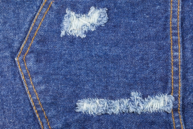 Blauwe gescheurde denim jeans textuur