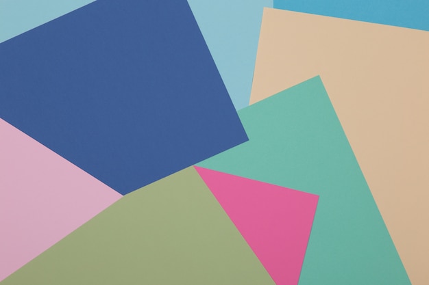 Blauwe, groene, gele en roze achtergrond, gekleurd papier verdeelt geometrisch in zones, frame, kopie, ruimte.