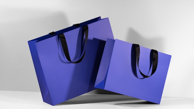 Blauwe papieren boodschappenzakken met zwarte handgrepen