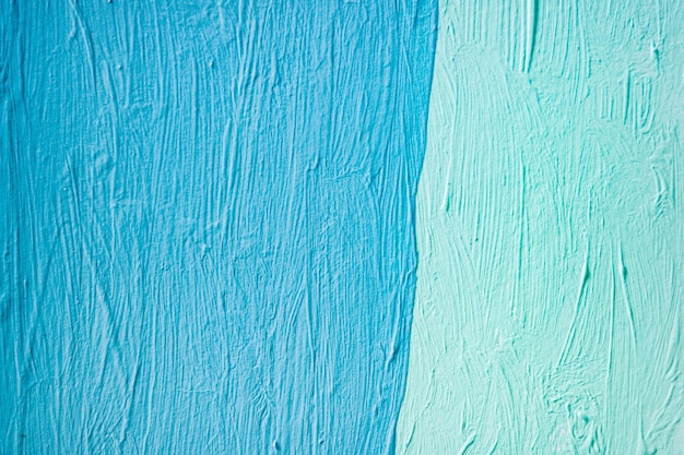 Blauwe verftextuur op een canvasoppervlak als achtergrond