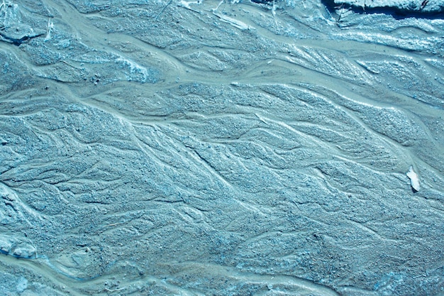 Blauwe zandtextuur met golvende lijnen en waterstralen in warme kleuren Sand Surface After The Rain