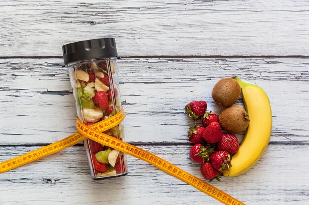 Blender glass with fruit for making smoothies