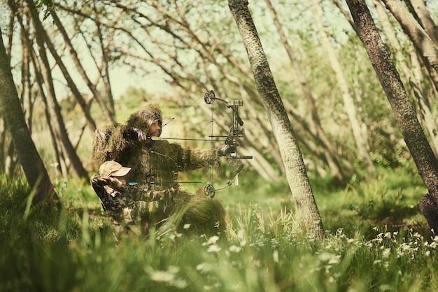 Blending right in to their surroundings Shot of a father and son in camouflage hunting with bows and arrows in the woods