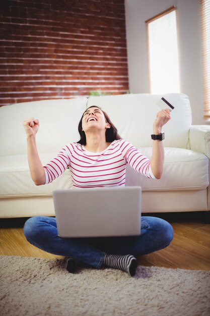 Blije vrouw die online het winkelen doet