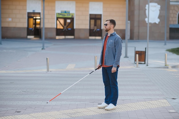 Blind man People with disability handicapped person and everyday life Visually impaired man with walking stick