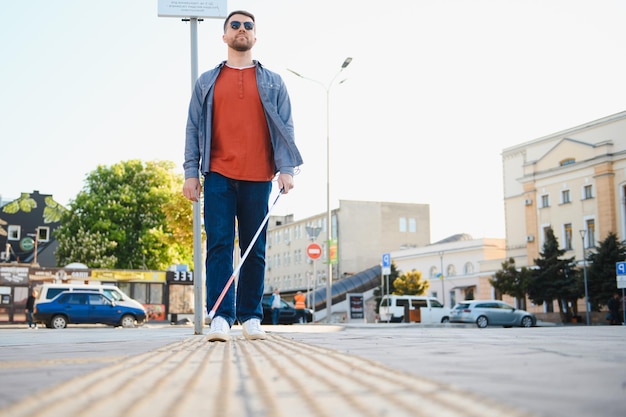 Blind man People with disability handicapped person and everyday life Visually impaired man with walking stick