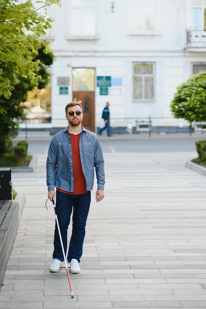 Blind man People with disability handicapped person and everyday life Visually impaired man with walking stick