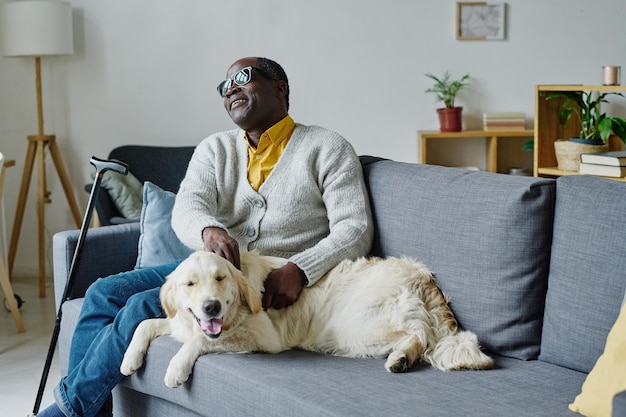 Blind man with guide dog at home