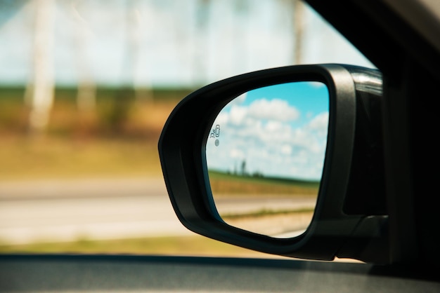 A blind spot monitoring sensor on the side mirror of a modern\
car