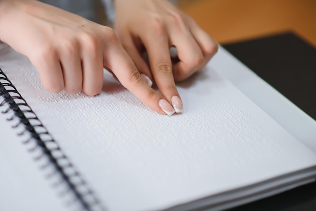 Blind woman read book written in Braille