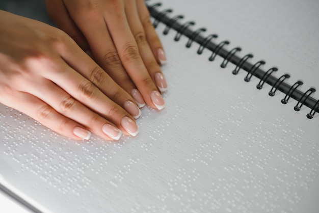 Blind woman read book written in Braille