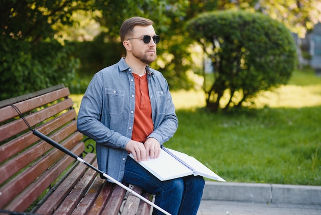 Blinded man reading by touching braille book