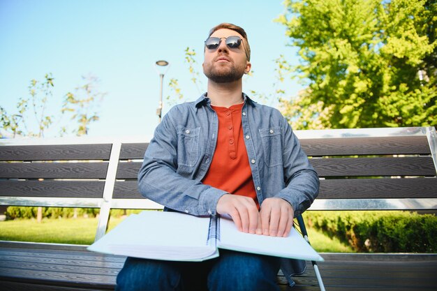 Blinded man reading by touching braille book