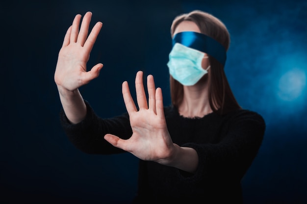 Blindfolded woman with medical mask