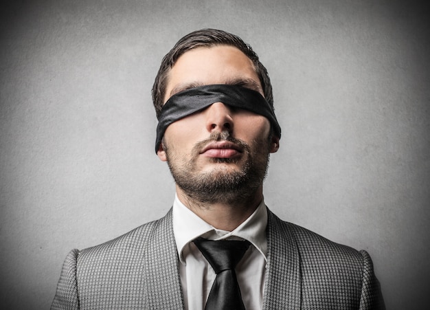 Blindfolded young businessman