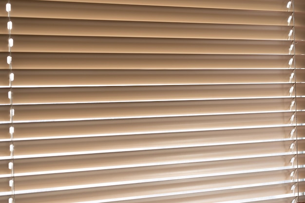 Blinds on the window light passing through the blinds