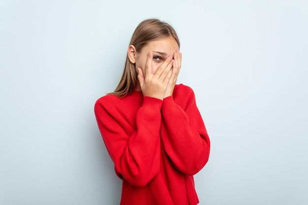 Blink at the camera through fingers embarrassed covering face