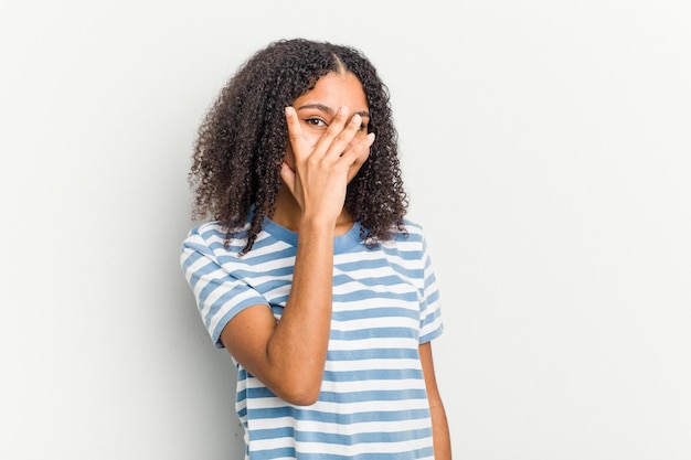 Blink at the camera through fingers embarrassed covering face