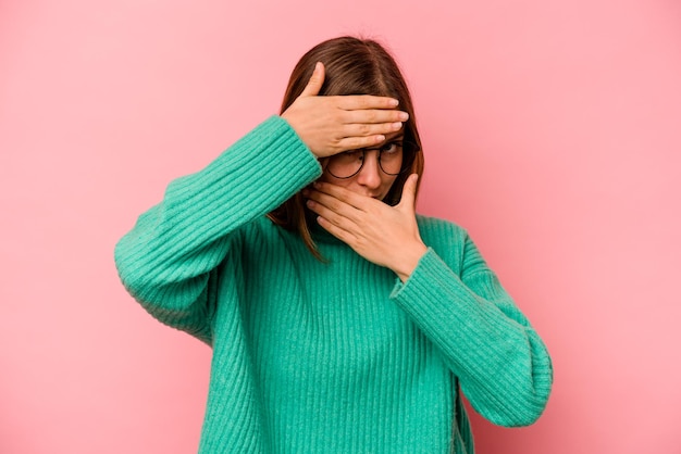 Blink at the camera through fingers embarrassed covering face