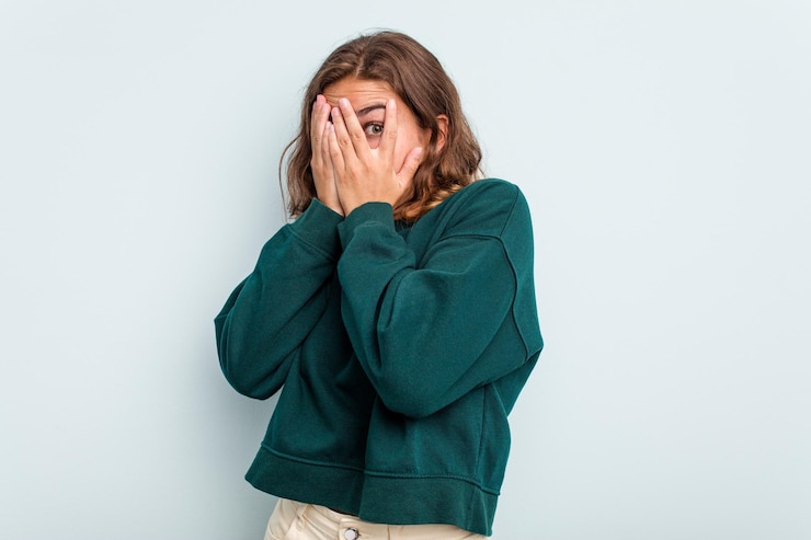 Photo blink through fingers frightened and nervous