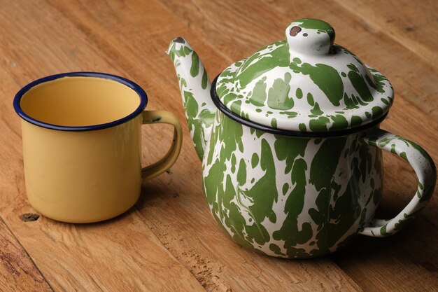 Photo blirik teapot. antique teapot with irregular green and white pattern. drinkware. enamel kitchenware.