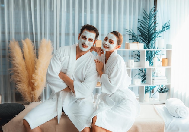 blissful couple in bathrobe with facial cream mask quiescent