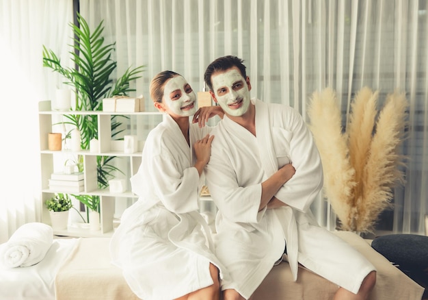 blissful couple in bathrobe with facial cream mask quiescent