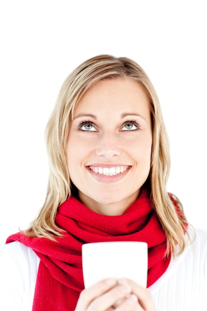 Blissful young woman holding a cup wearing a scarf 