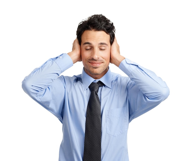 Blissfully ignorant Studio shot of a handsome businessman covering his ears