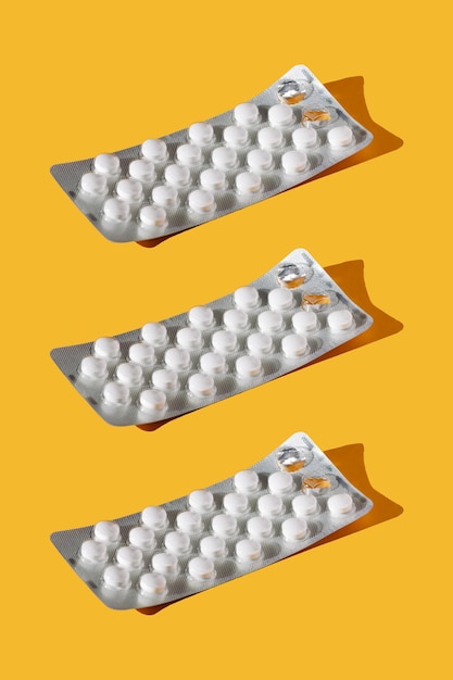 Blister pack with pills on a yellow background