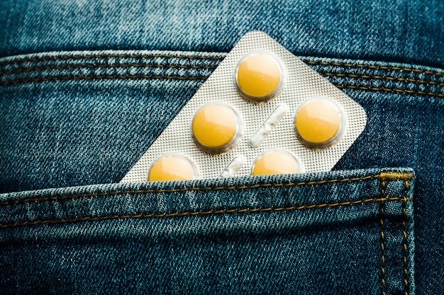 Blister pack of yellow pills in jeans pocket