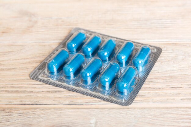 Blister package with Vitamin on color background Medicine pills on a light background Medicines and prescription pills flat lay background blue medical tablets in blister