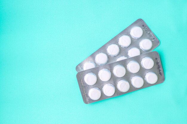 Blister packs with medicines on blue background