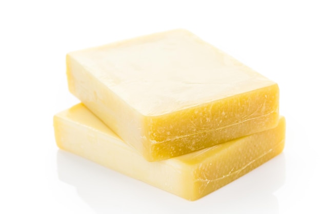 Bloccks of gruyere cheese on a white background.