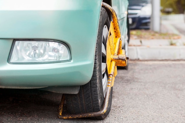 Photo block on car wheel by wheel lock. locking wheels of vehicle.