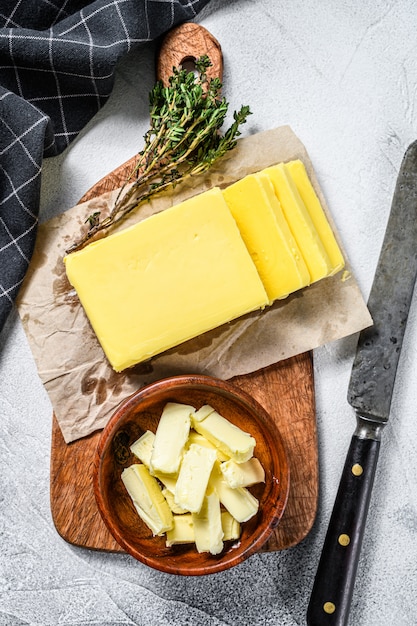 Block of fresh Butter on Gray table.