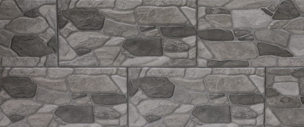 The blocks of solid stoneThe wall of gray stoneVintage rustic weathered uneven background